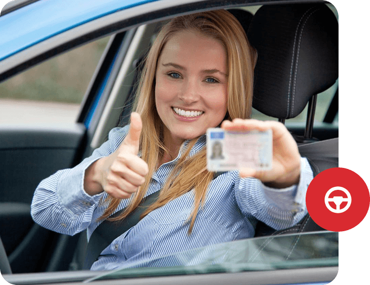 A woman in the drivers seat of her car holding up a license.